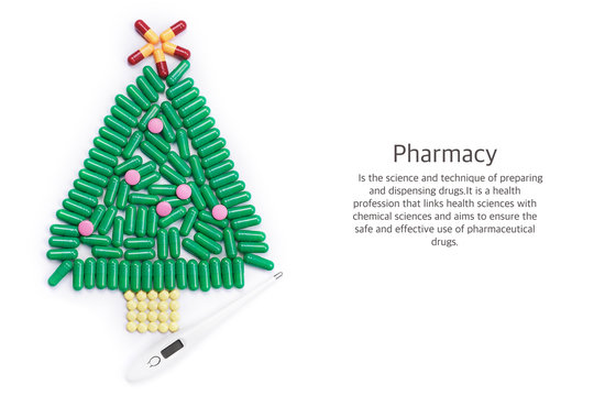 Tablets in form of Christmas tree and thermometer under it