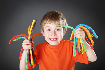 Young boy holding colorful licorice candy