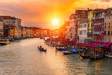 Fototapeta na wymiar Sunset view of Grand Canal with gondolas in Venice. Italy