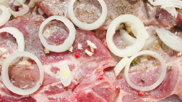 The process of cooking a steak: onion rings lie on a steak