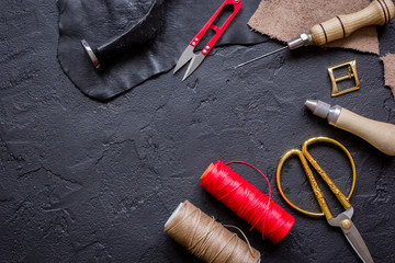 leather craft instruments on dark background top view mock up