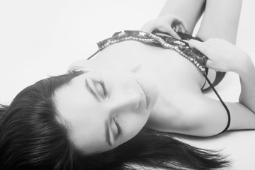 beautiful girl in lingerie lying on white background, monochrome