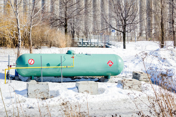 Green Propane Tank on a Snowy Field