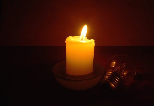 Burning Candle And Lamp.  Power Outage. Missing Electricity - Blackout Begin.	Power Outage.