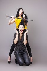 young woman cuts off hair with samurai sword