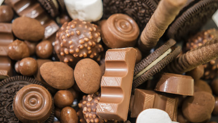 Chocolate, candies, and cookies on table