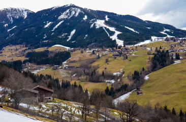 Beautiful view of the mountain and green village in winter without snow