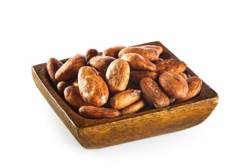 Raw cocoa beans in wooden bowl