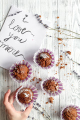 concept of Valentine's Day cupcakes wooden background top view