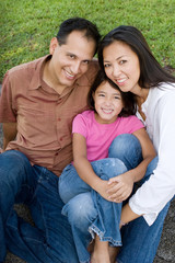Fototapeta premium Loving Asain parents and their daughters smiling.