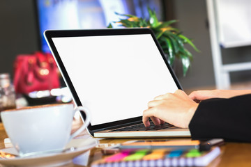woman hand working laptop on wooden desk in office