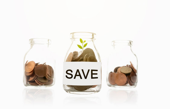save message on glass bottles, plant and coins, investment and business concepts