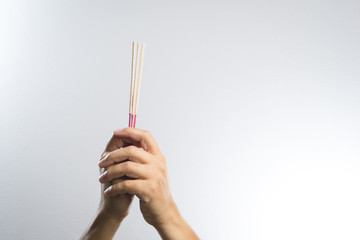 hand with incense stick