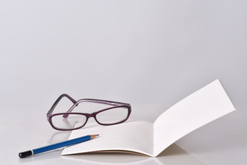 Glasses, pencil and notebook for planning