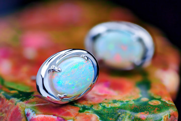 Silver earrings with white opal stone closeup
