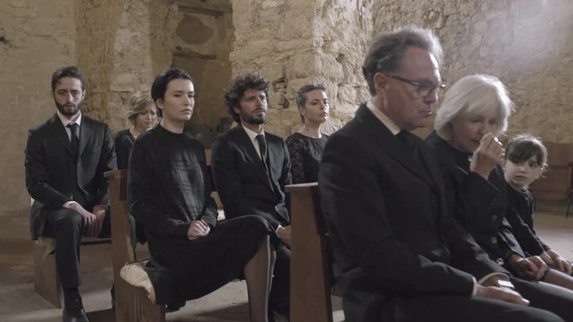 Grandmother crying at a funeral with granddaughter
