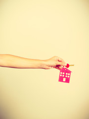 Person holding keys with pendant in house shape