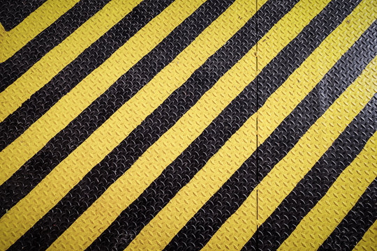 yellow and black marking warning sign, grunge background