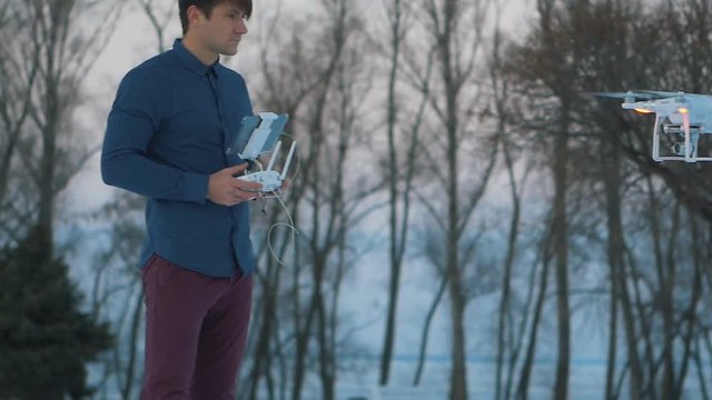 A man controls a drone at winter garden