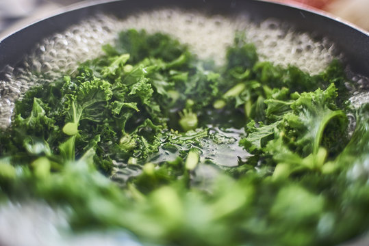 Kale boiling in a saucepan close-up