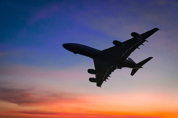 Air plane silhouette over the sunset cloud