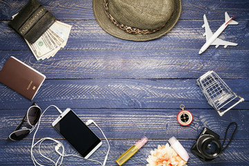 Outfit and accessories of traveler on blue wooden background
