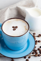 cappuccino and white milk jug on a white background