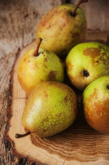 A group of fresh pears on wooden board