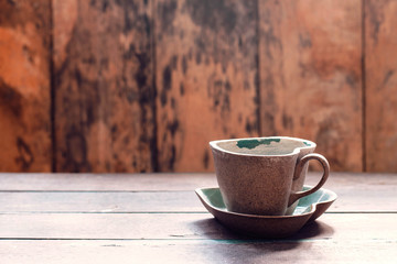 Cup and saucer on wooden.