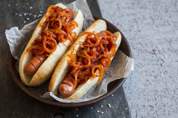 Hot dog with New York street style tomato onion sauce on a wooden background