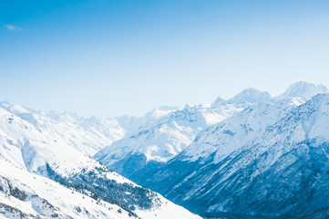 Fototapeta na wymiar Snow-covered mountains and blue sky.