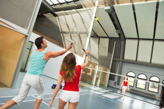 Young People Playing Badminton At The Gym