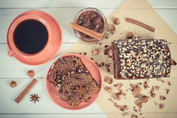 Vintage photo, Dark cake with chocolate, cocoa and plum jam, cup of coffee, delicious dessert