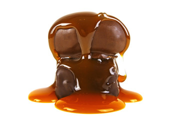 Two chocolate candies in caramel sauce on a white background