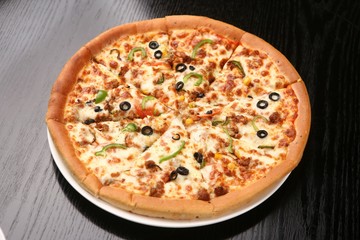 Combination pizza in black table