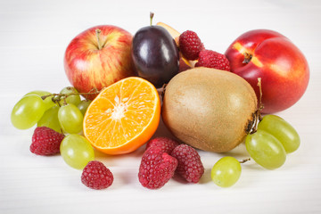 Naklejka na ściany i meble Fresh ripe fruits on white boards, healthy nutrition