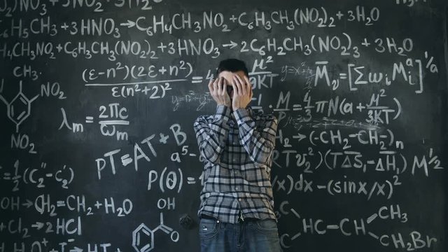 scientist man disappointed about problems experiment in chemical and mathematical equations room