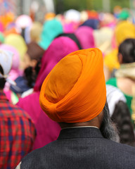 man with orange turban and thick beard during the event