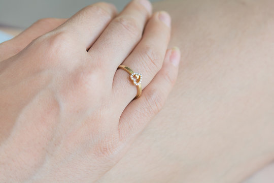 a heart-shaped  ring on a finger