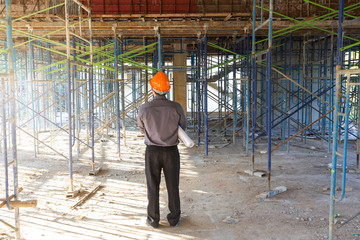 Construction concepts, Engineer and Architect working at Construction Site with blueprint