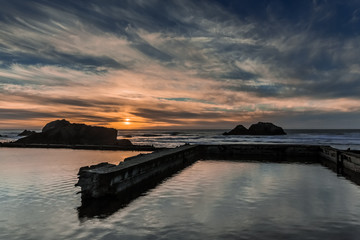 Sunset over Sutro Baths, San Francisco, California, USA. The Pacific Ocean and ruins of Sutro Baths, site of a large historical bathhouse.