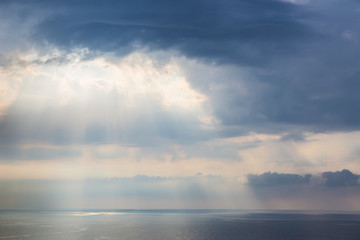 sunset in the cloudy sky over the sea