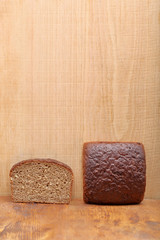 Healthy bread with seeds on wooden background and empty space fo