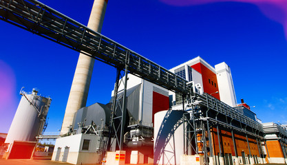 Fototapeta premium Modern industrial factory against blue sky