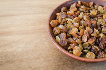 Dried Organic Raisin in Bowl on Wooden BackgroundClose-up.