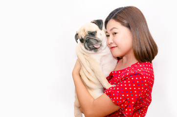 Beautiful asian woman hugging her pug dog isolated on a white background