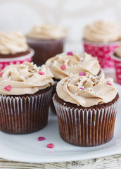 Chocolate cupcakes decorated with cream rose hearts