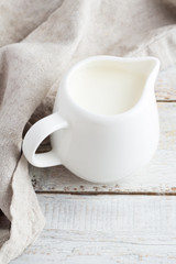 White milk jug with milk