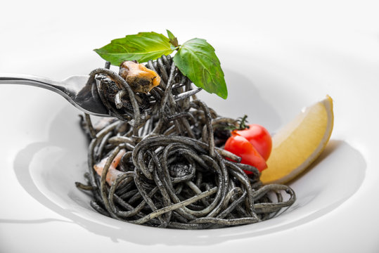 Dish painted black cuttlefish ink spaghetti with seafood