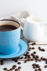 coffee black, white milk jug and coffee beans